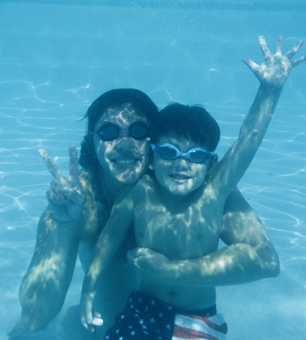 Jen and Zac having fun under water at the pool