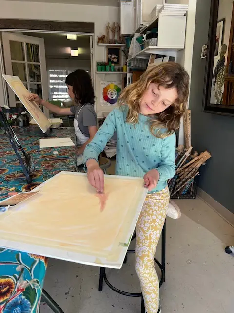 Young artist happily working on project