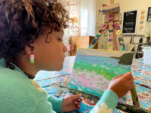 artist reviewing artwork with many beautiful colors