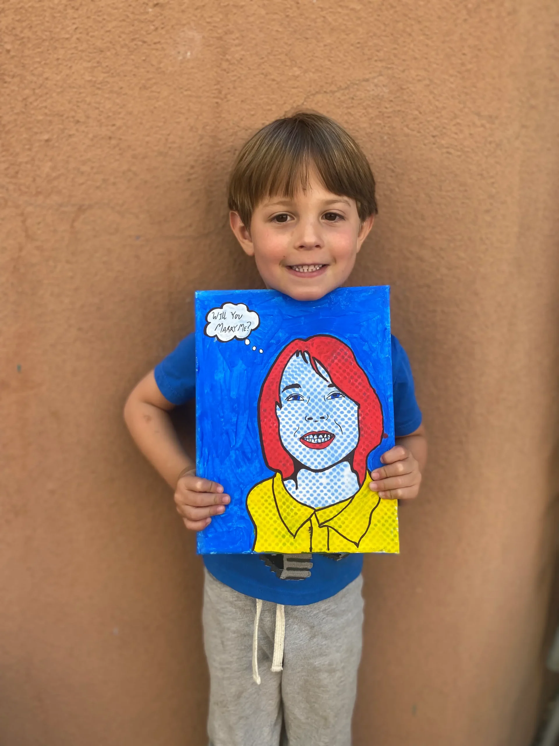 young boy artist holding artwork of a lady in cool style