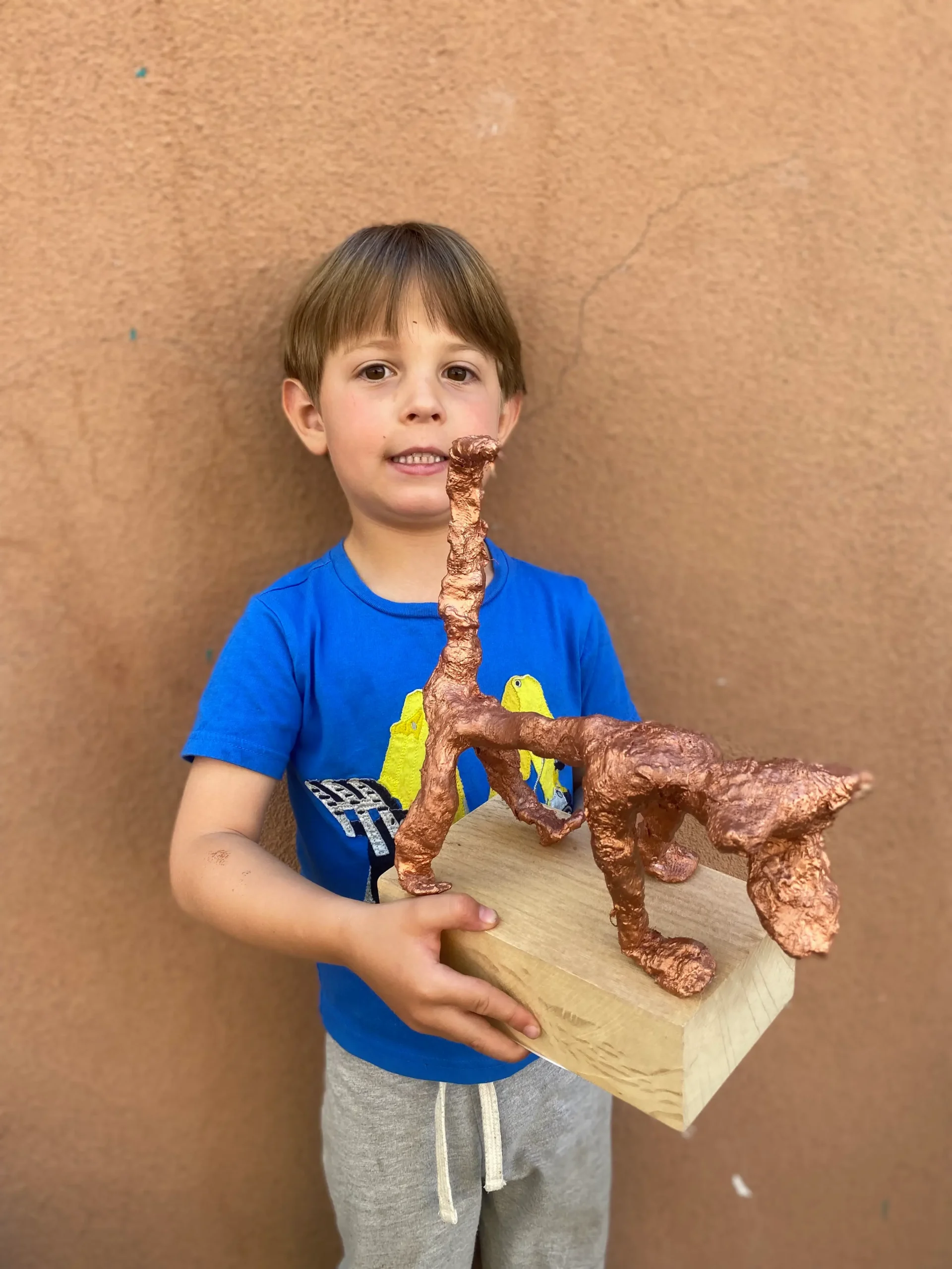 boy artist holding his cool sculpture
