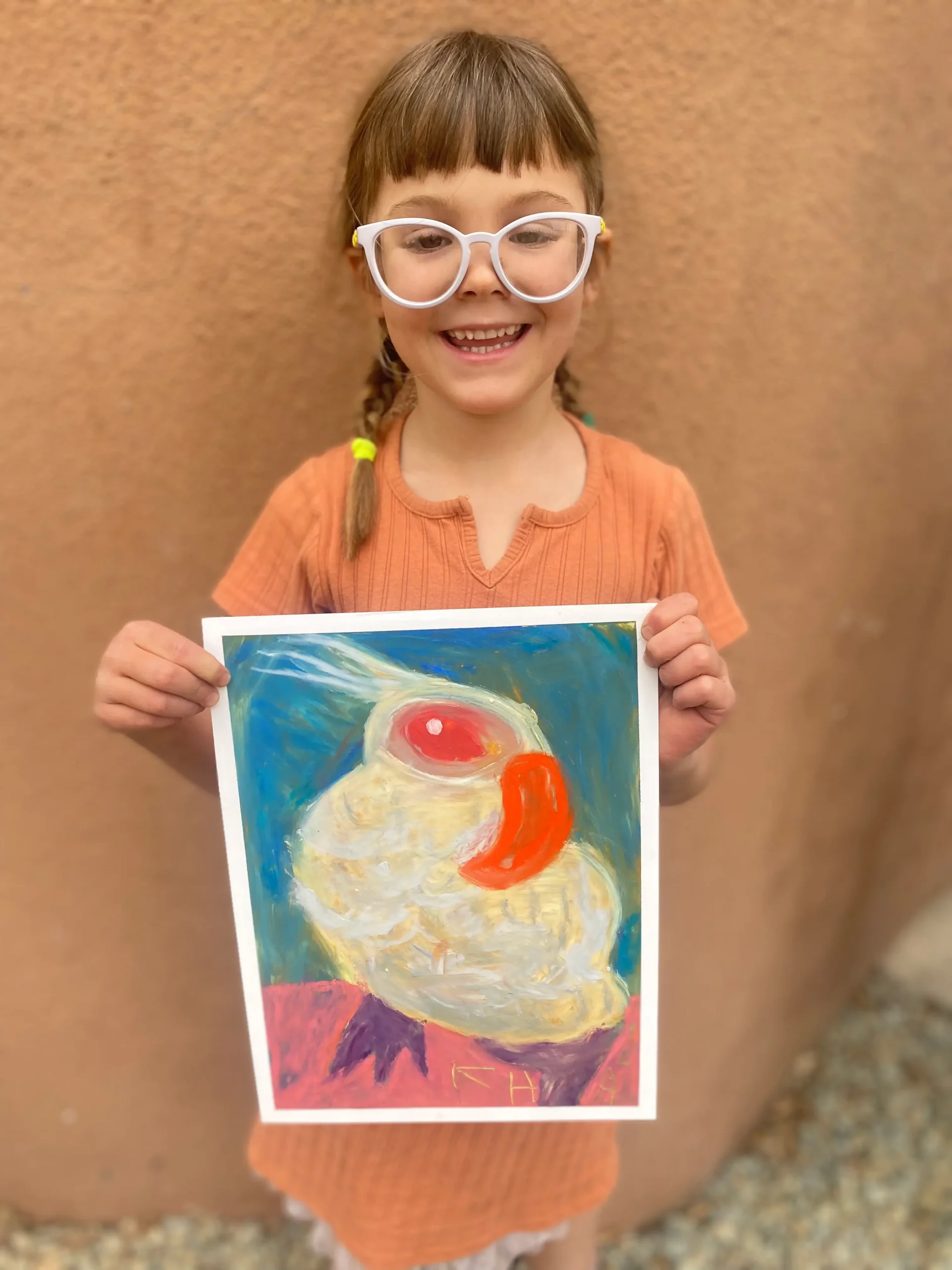 young girl artist holding picture of bird in cool style