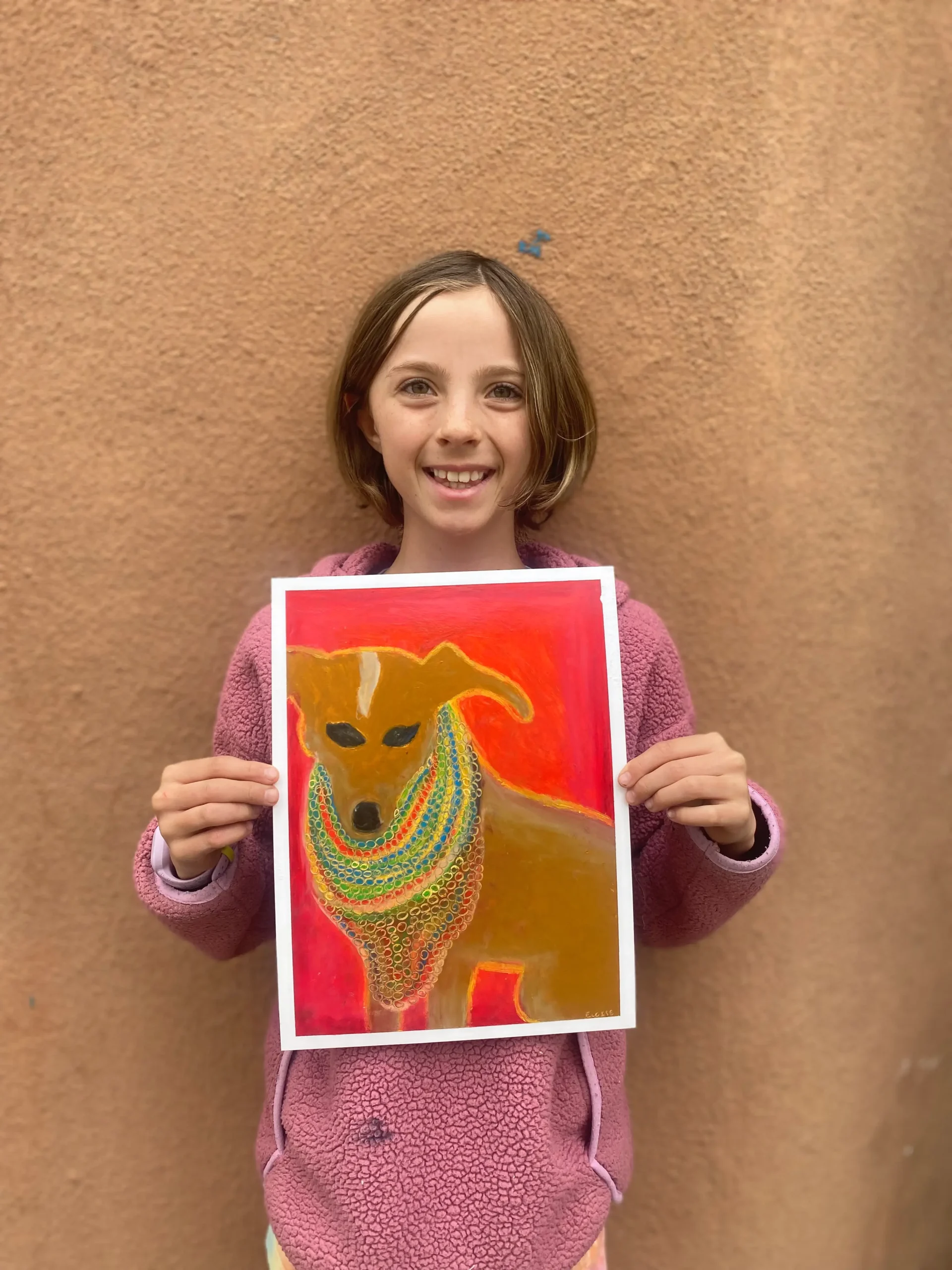 young artist holding picture of dog with red background and cool style