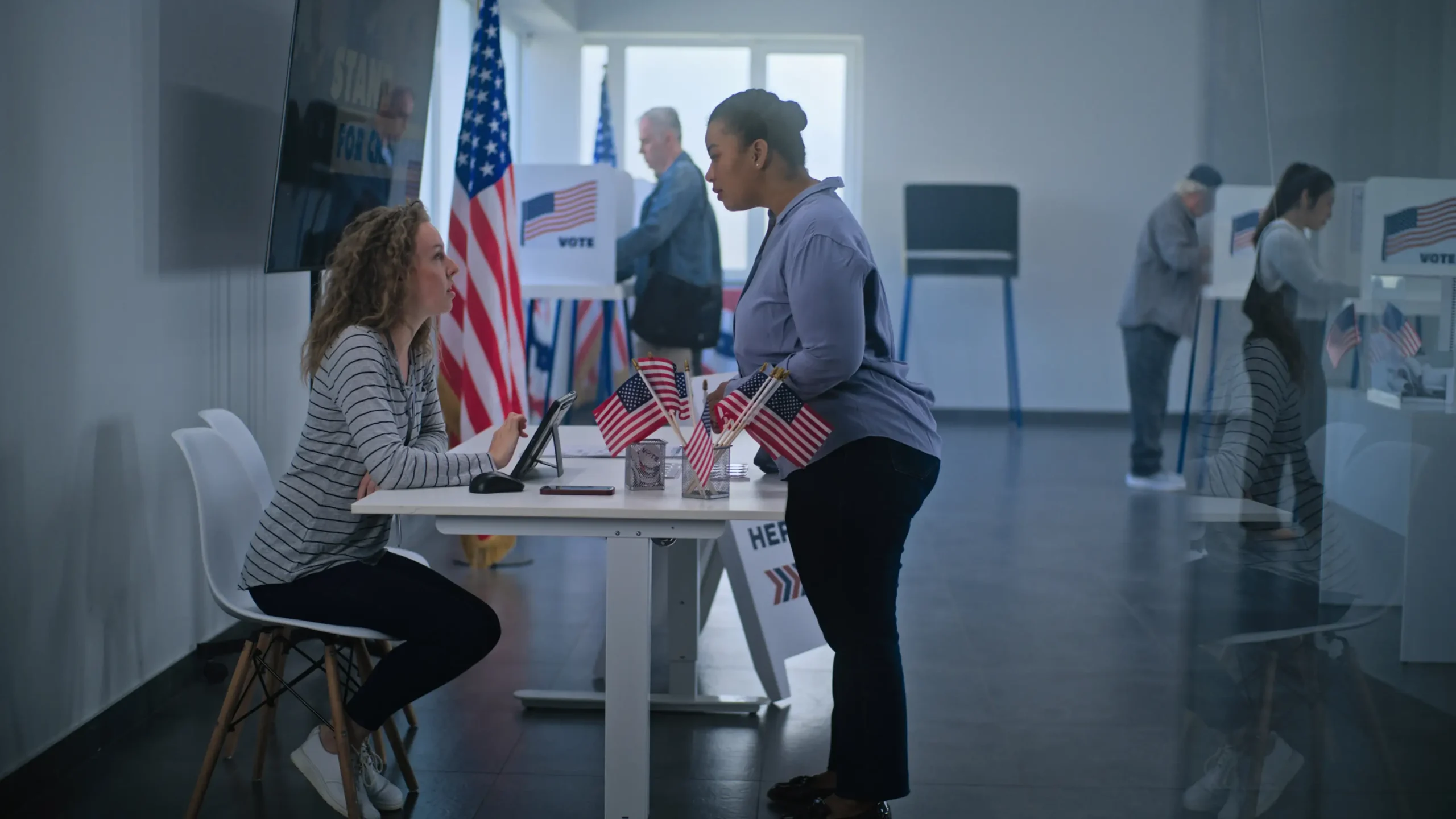 woman at voting location speaking with staff