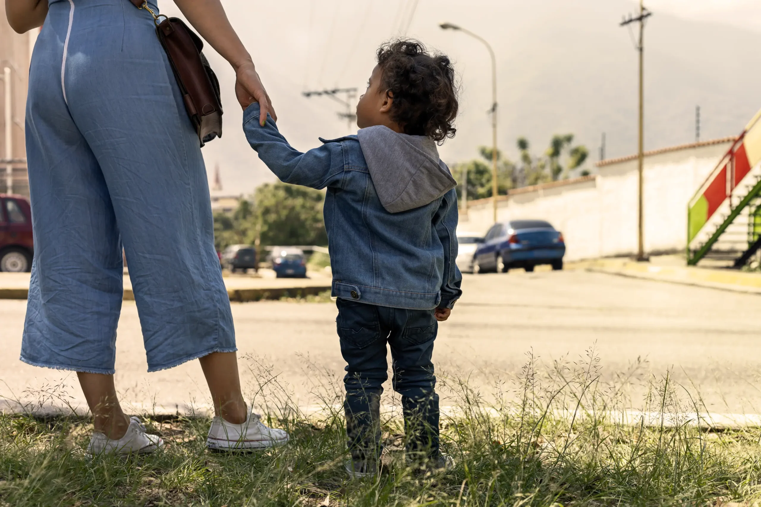 woman holding childs hand