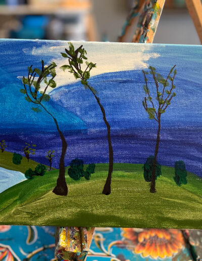 Painting of trees by a lake