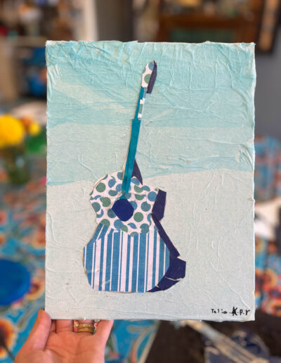 Painting of guitar with stripes and pokadots