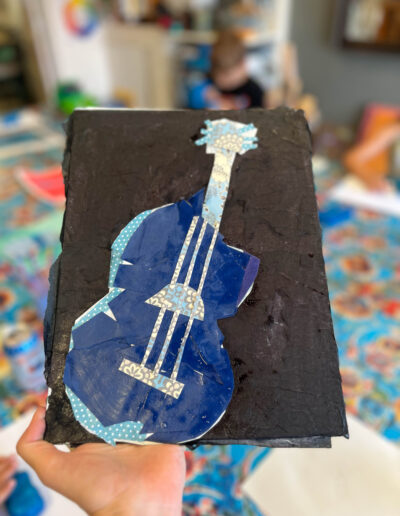 Painting of dark blue and light blue guitar