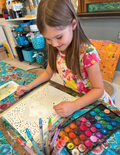 girl painting with many colors