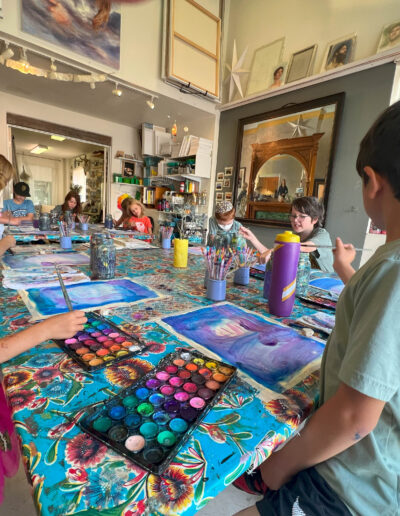 active students painting in the studio