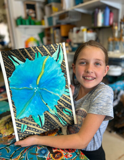 young girl displays her artwork