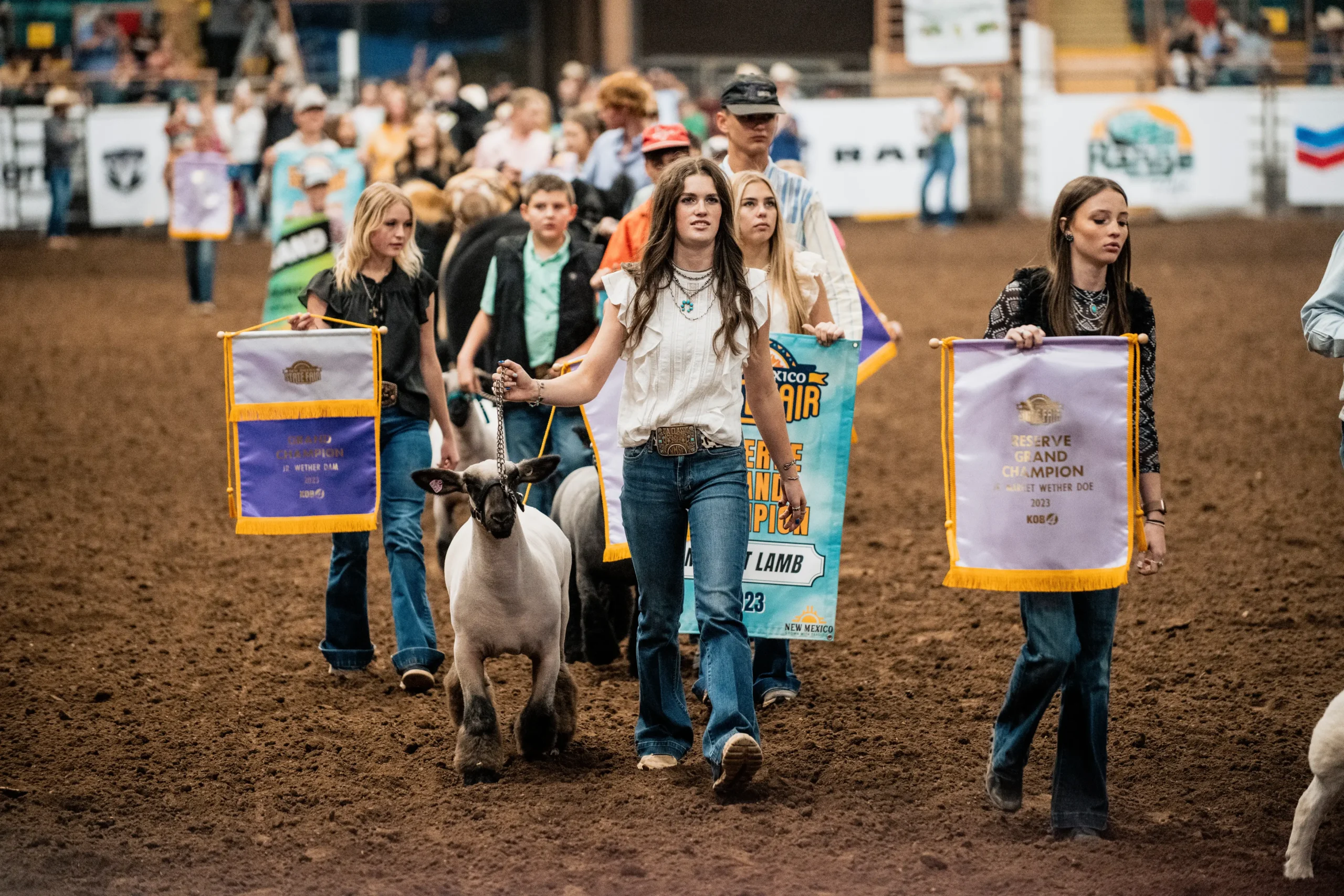 Grand champion and reserve grand champion livestock parade through Tingley Coliseum<br />
during the PRCA Rodeo.