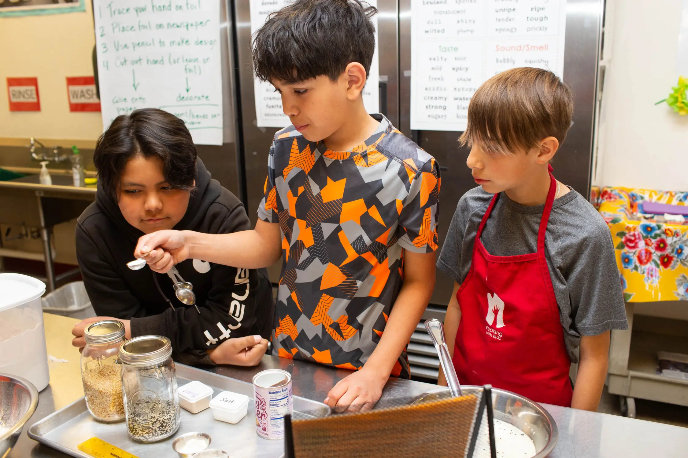 Fifth graders measuring ingredients for flatbread.