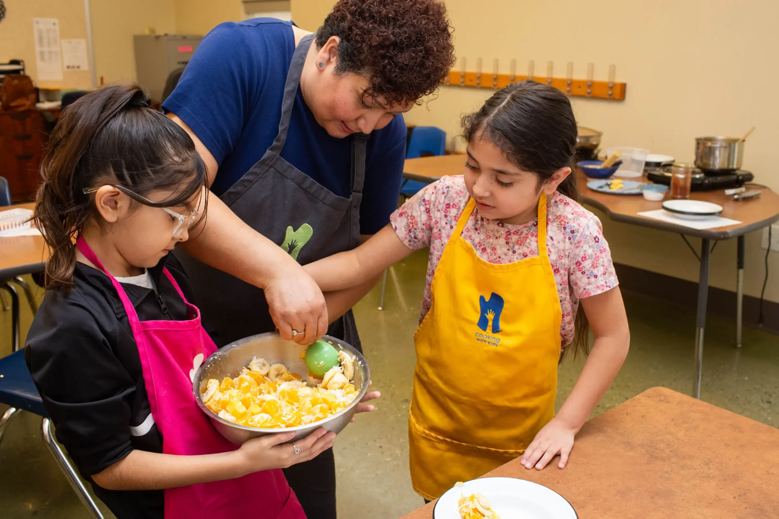 With some guidance, kids can help plate food to be served at celebrations.