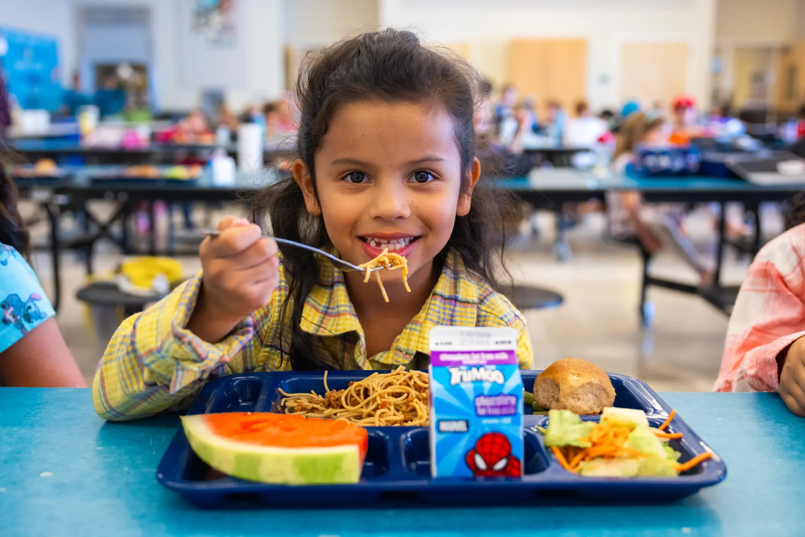 Child getting ready to take a bite of spaghetti.