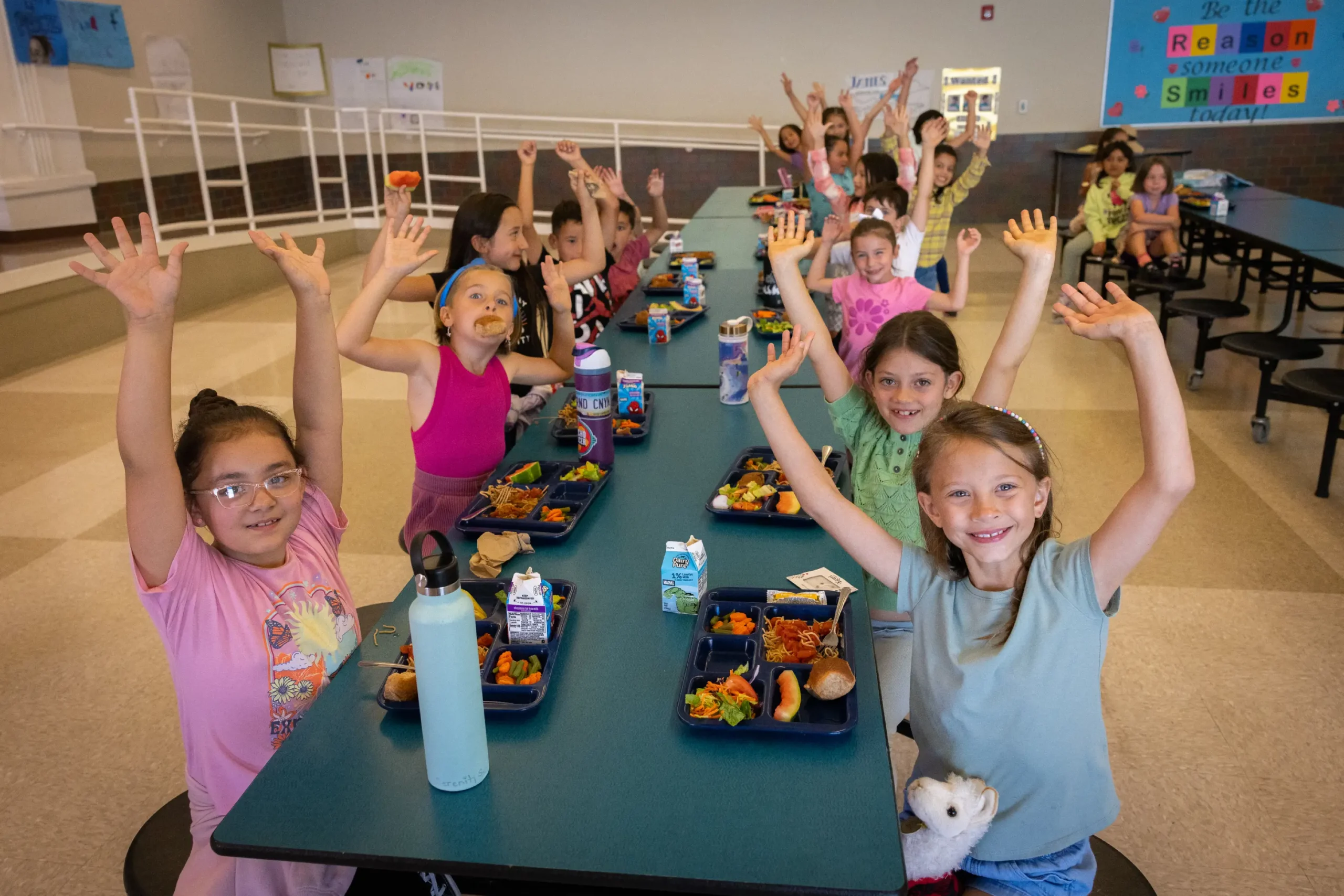 Children showing excitement for their delicious and nutritious scratch-made school lunch.