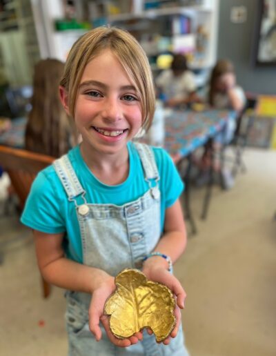 Girl holding her artwork