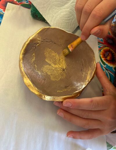 Student painting a bowl