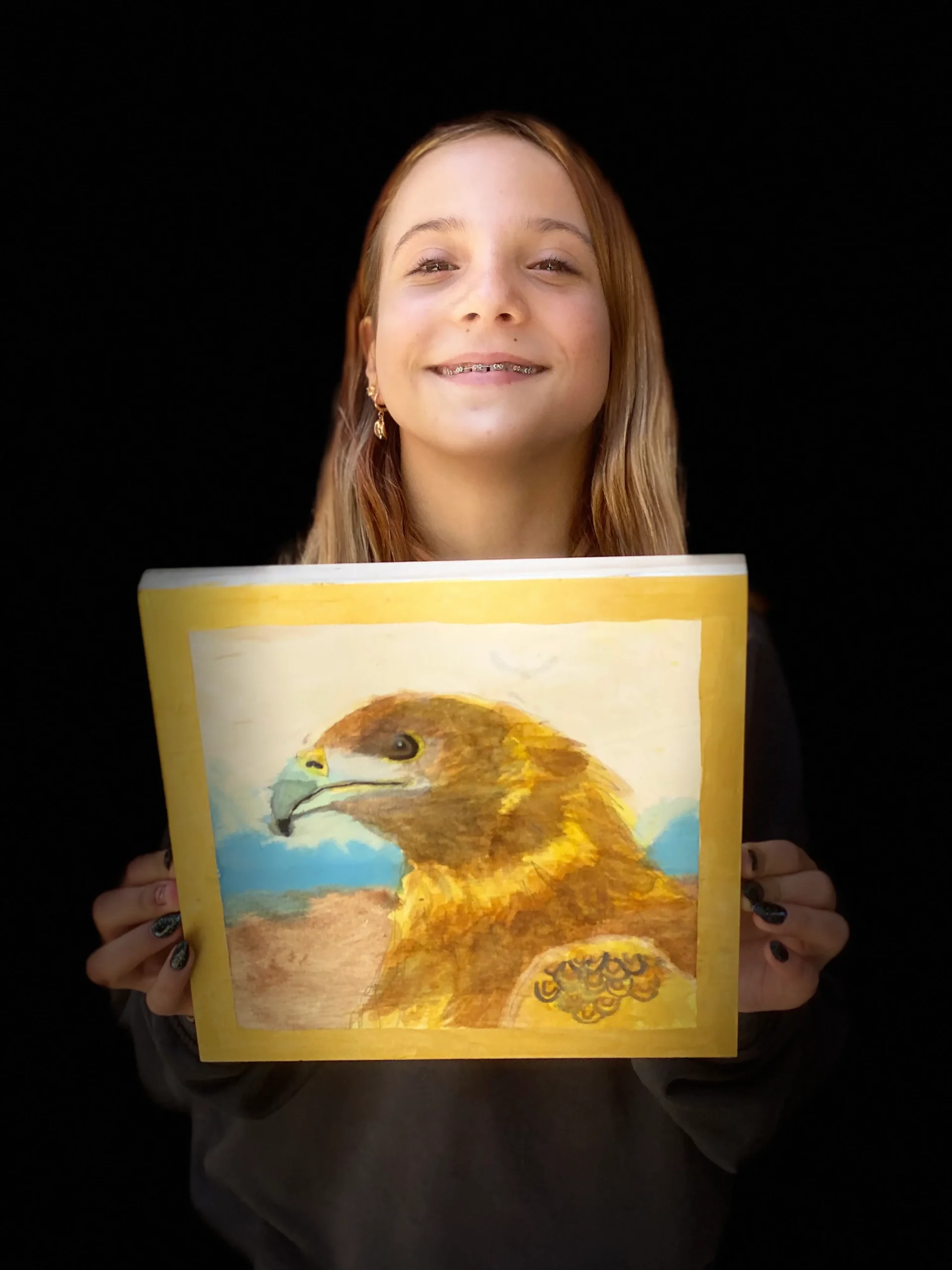 girl showing her hawk painting