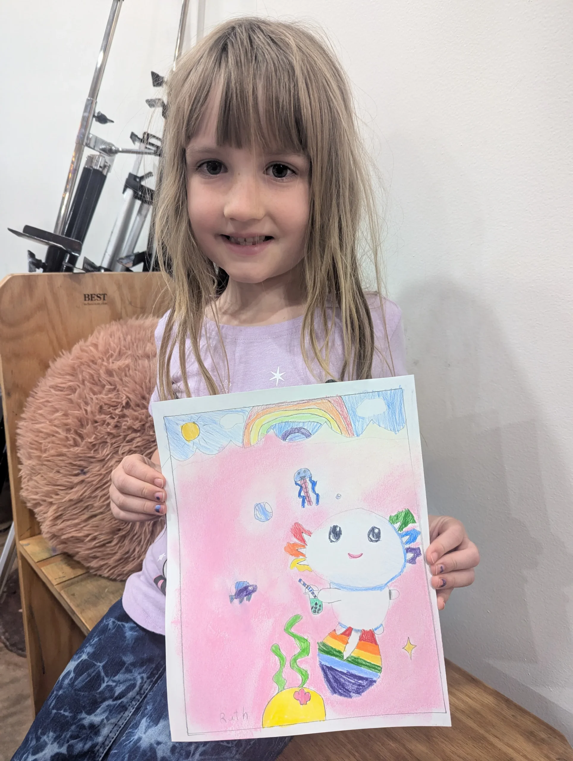 student showing her picture of a kitty cat