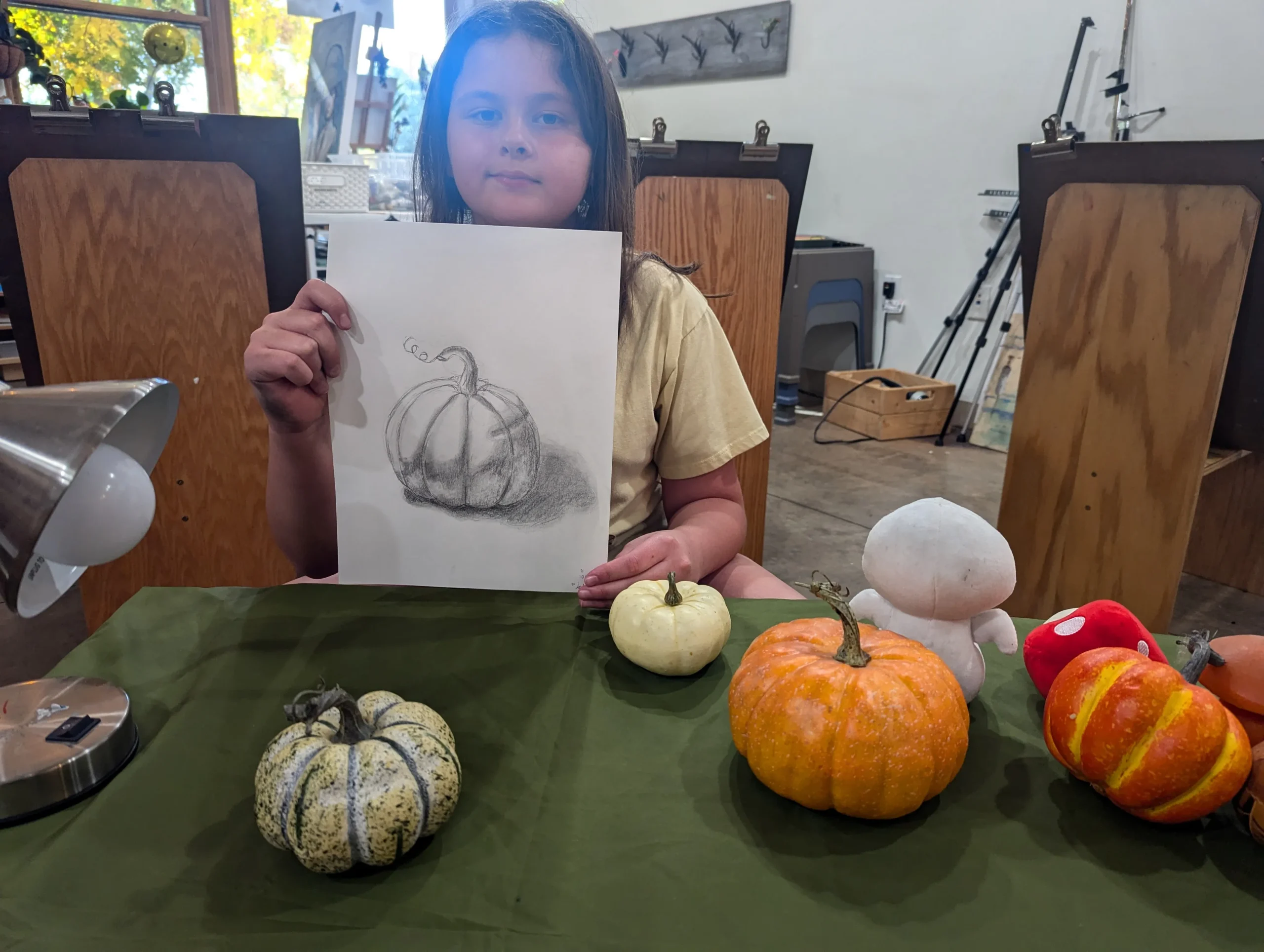 girl displaying her painting