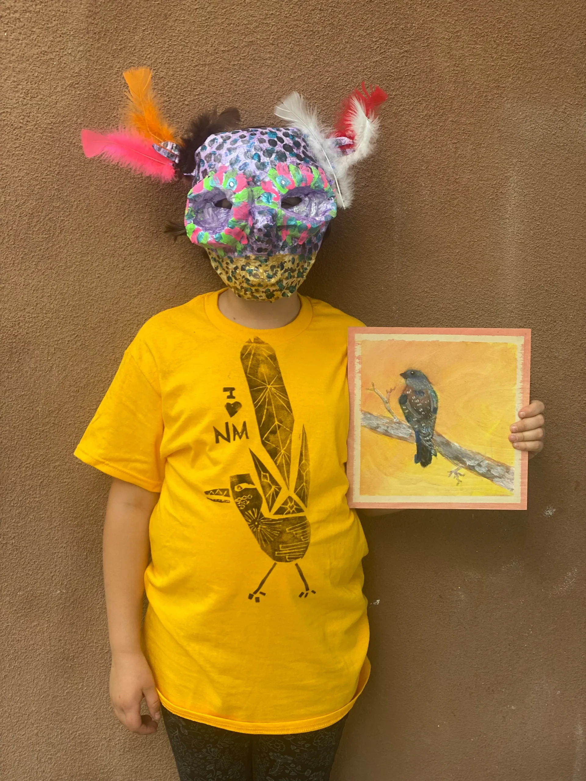 student displaying bird painting