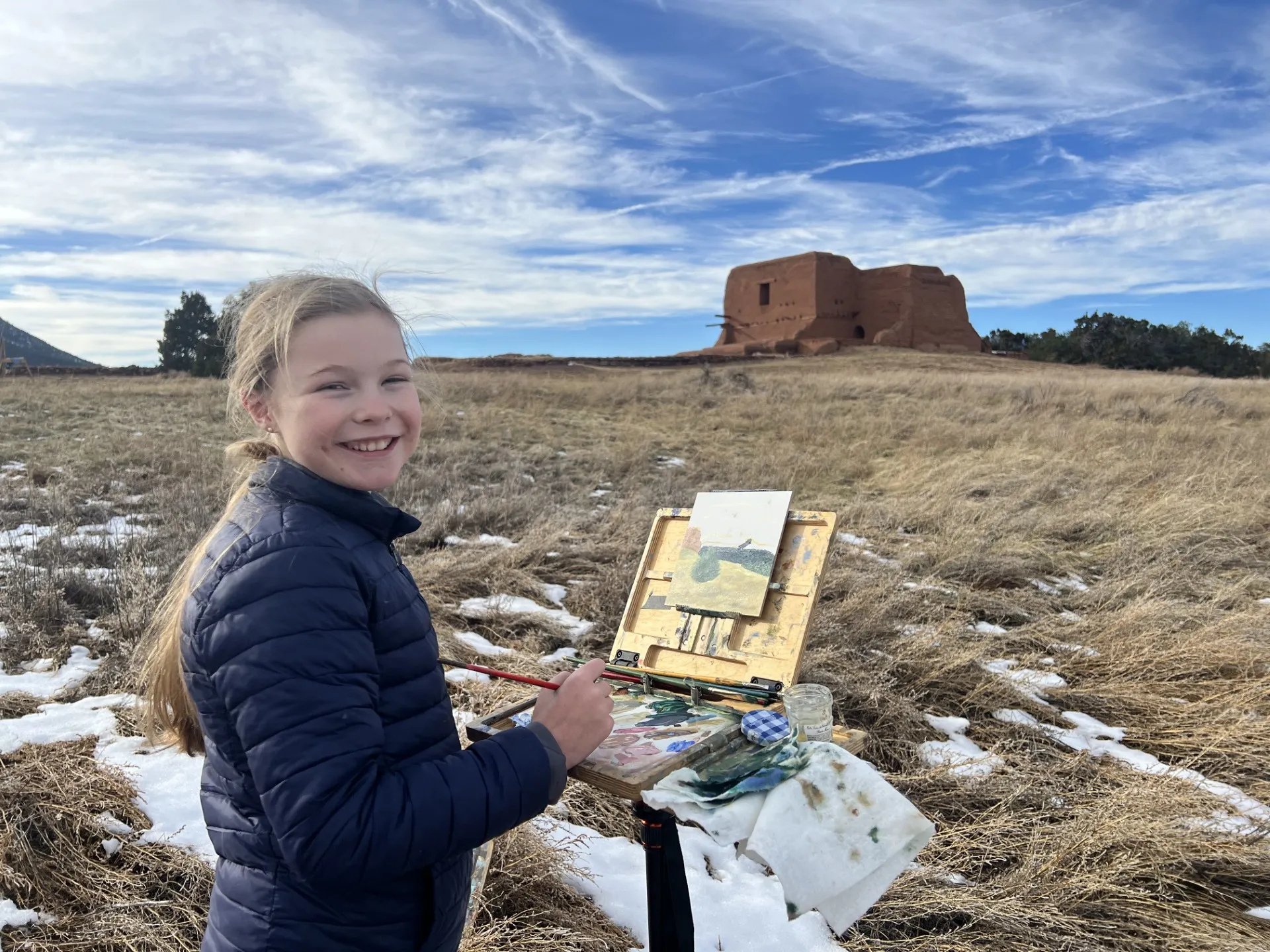 girl painting outside in beautiful landscape