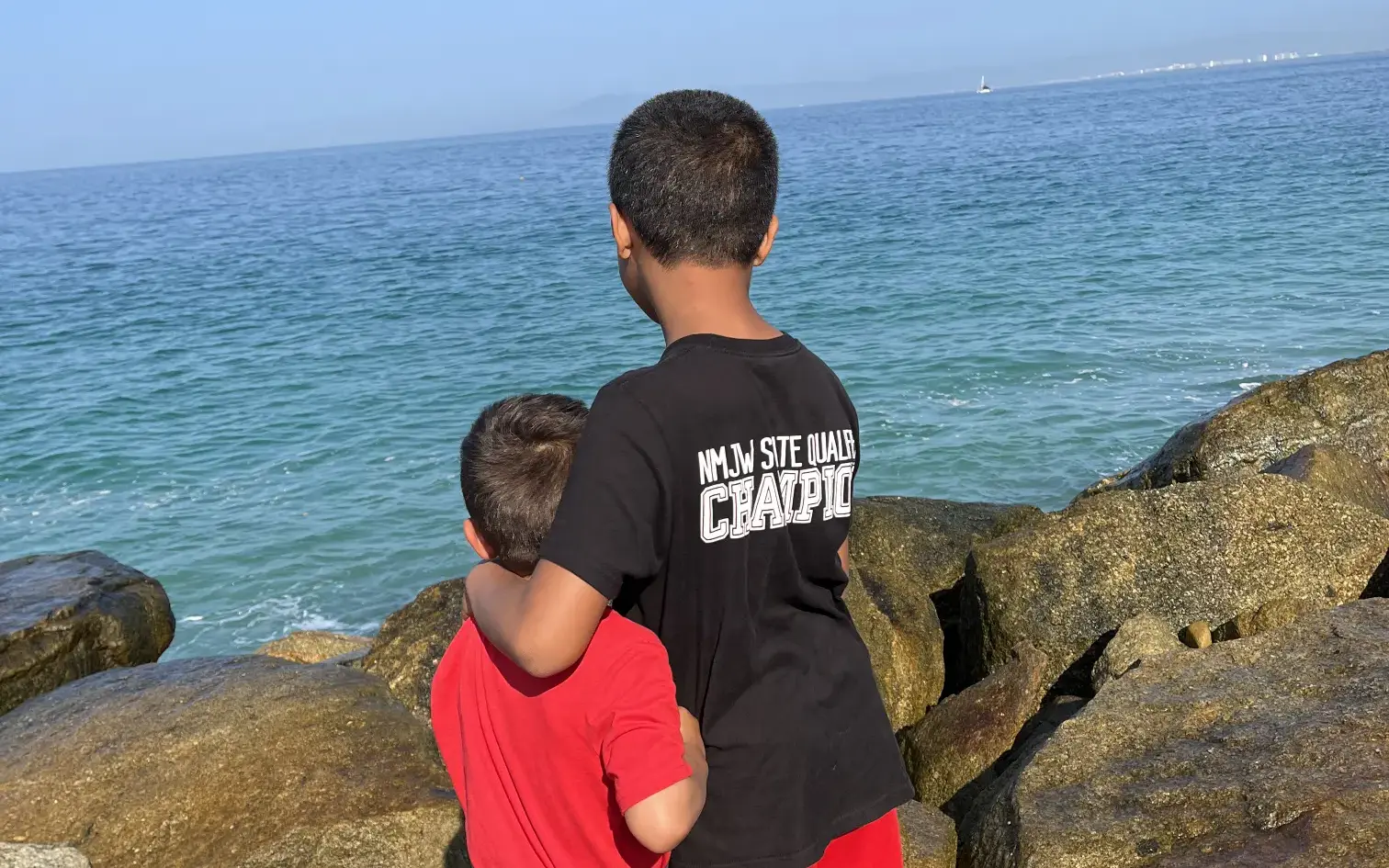 Brothers enjoying a beach day in Mexico with their family one year after adoption.