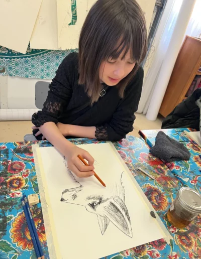 student drawing a wolf