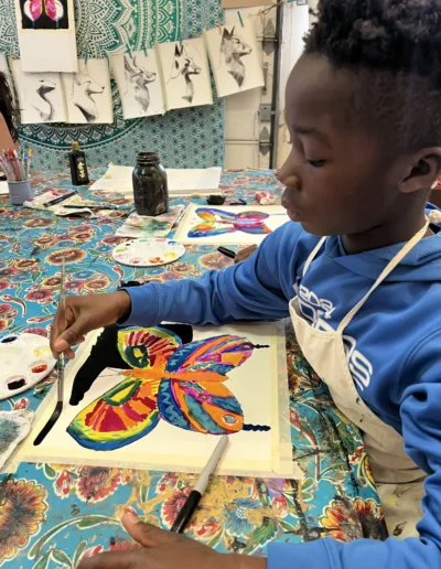 Student painting a butterfly