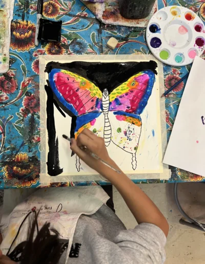 Student painting a butterfly