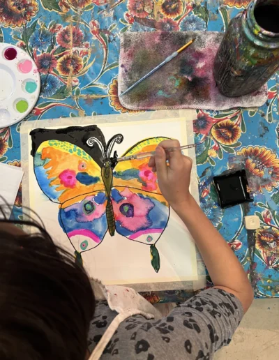 Student painting a butterfly