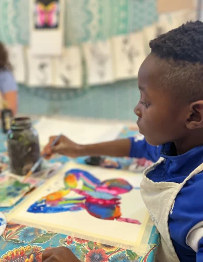 Student painting a butterfly