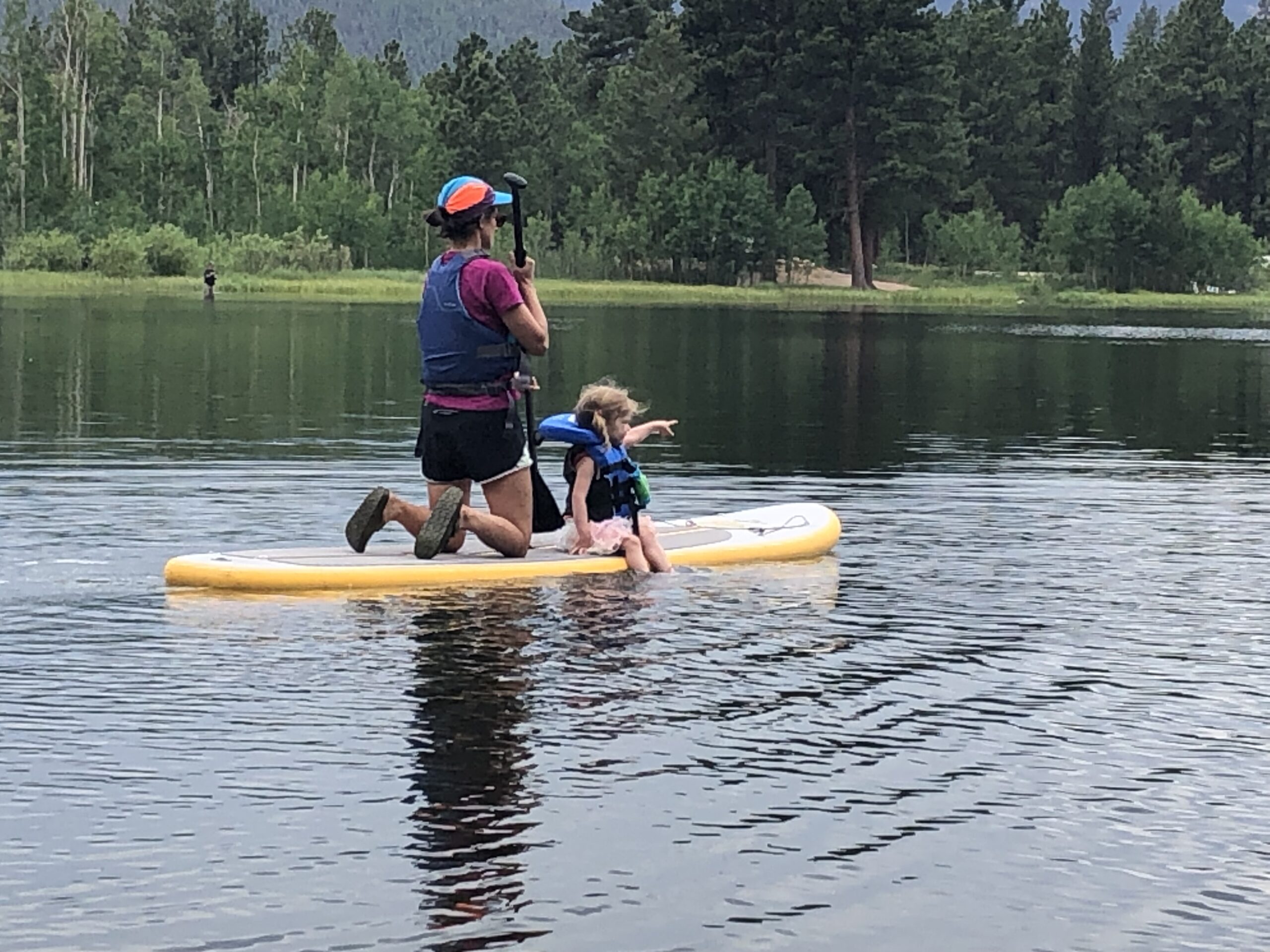 Mother and daughter paddleboarding