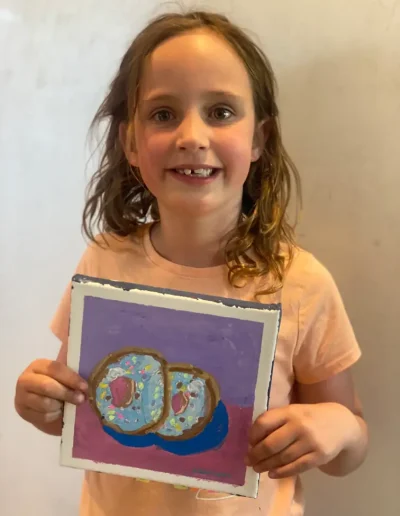 young student showing her painting