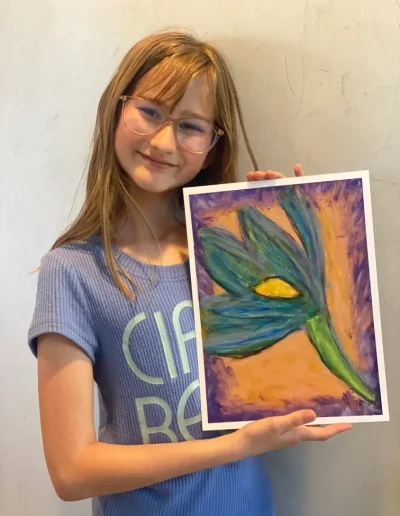 young student showing flower painting