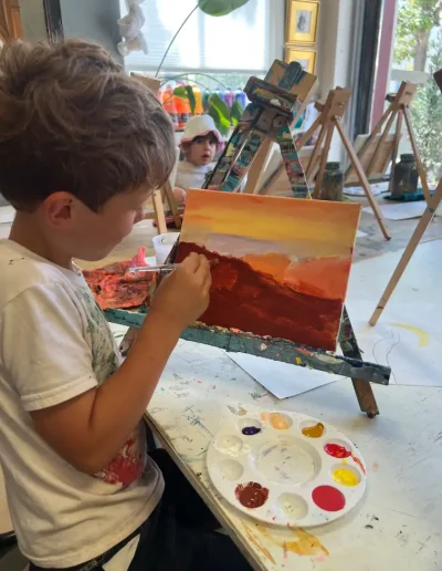 boy student painting landscape